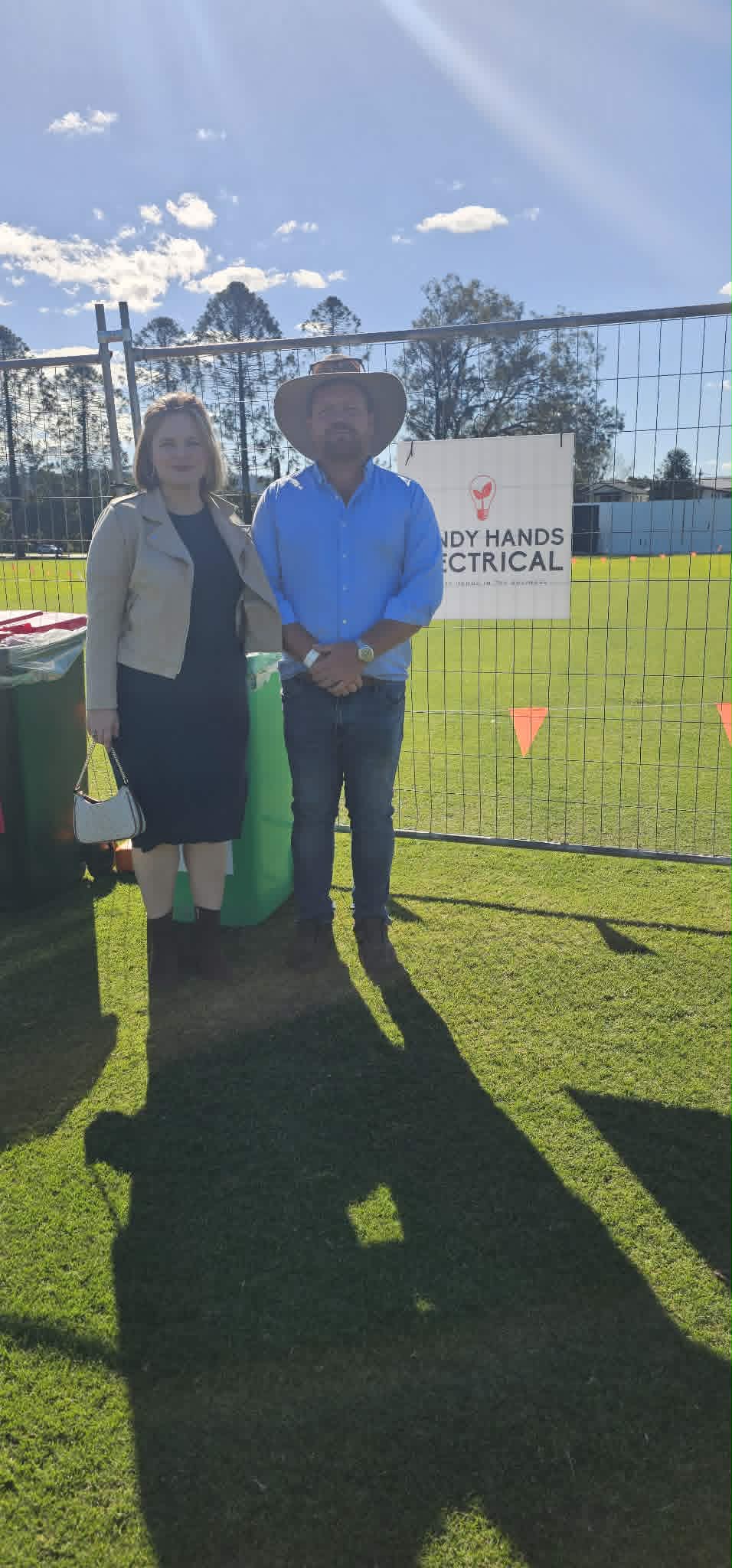 Boden Snell beside the Handy Hands Electrical sponsor sign at a junior rugby ground in Brisbane