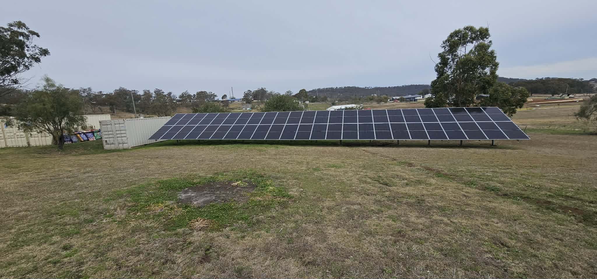 Ground-mounted solar array in an open paddock on a rural Queensland property