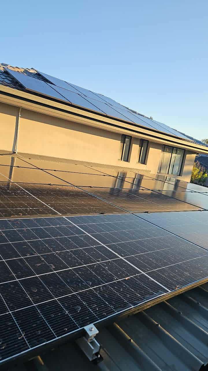 Rooftop solar across the tiled and Colorbond roofs of a two-storey Queensland home