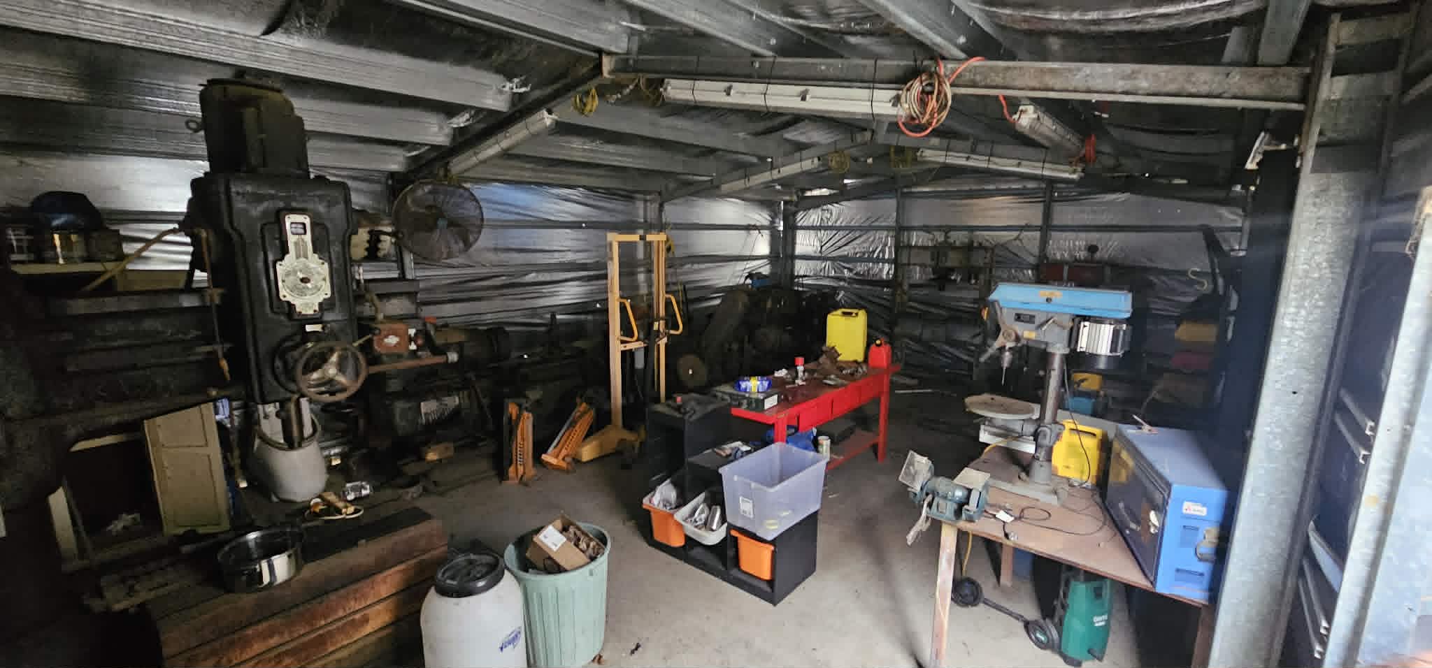 The Handy Hands Electrical workshop in Dinmore with a drill press, benches and tools